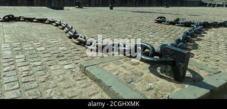 Old chains laying on the walkway to remind us of Kings Lynn`s heritage. Stock Photo
